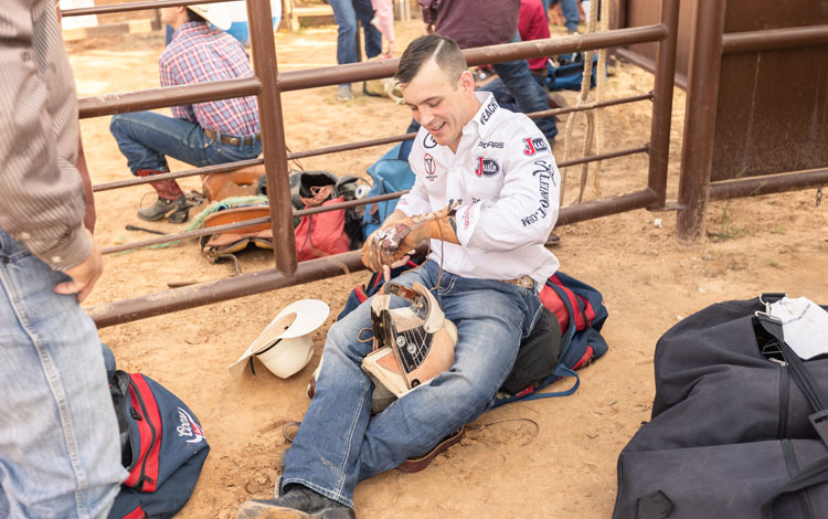 Jinete a pelo, Tim O'Connell, poniendo colofonia en su guante de montar y calentando con su aparejo a pelo antes de competir en un rodeo.